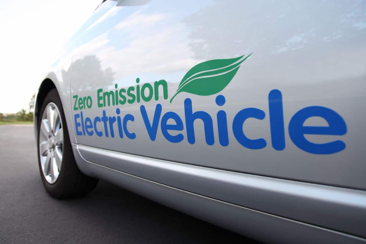 photo of a zero emission electric vehicle with the words zero emission electric vehicle printed on its side