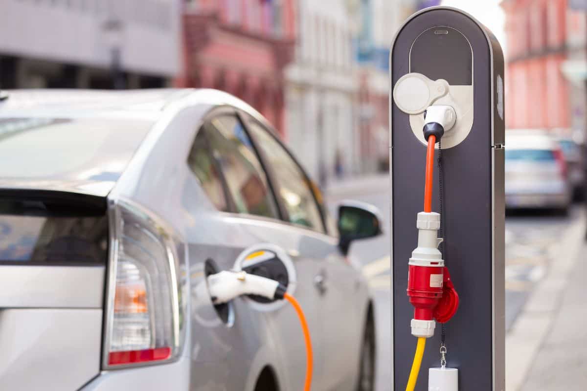 photo of a car being charged in a city charging point on the street