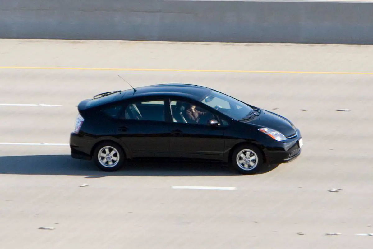 photo of a black toyota prius driving on a freeway