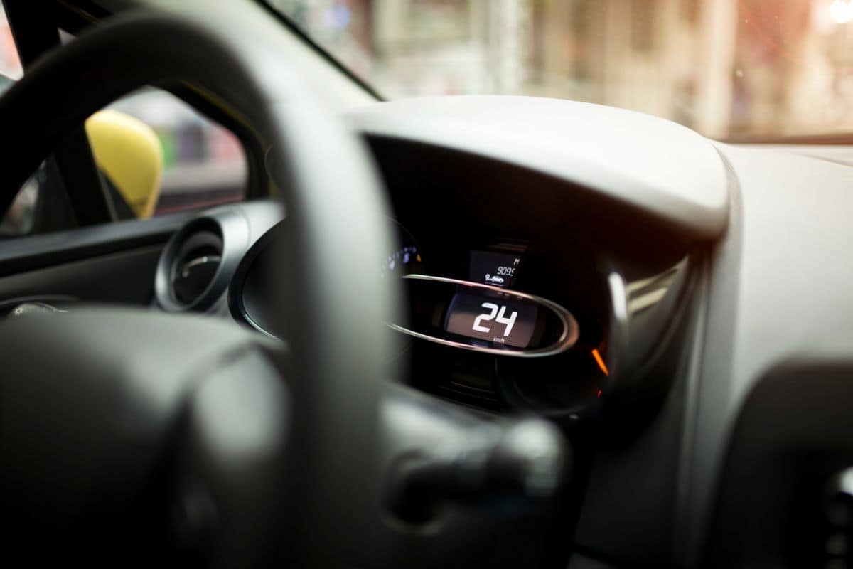 photo of the inside of a hybrid electric car, showing steering wheel and dashboard