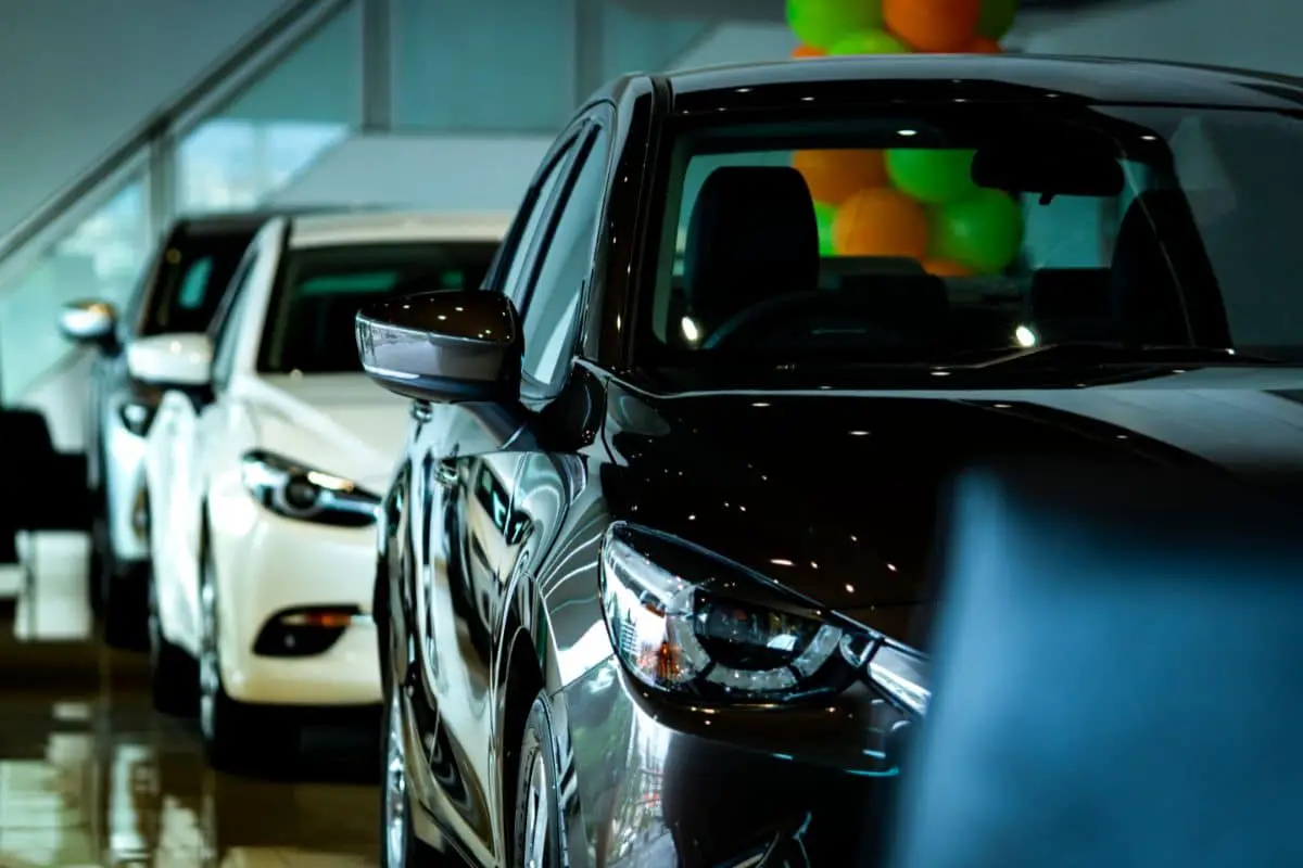 line of hybrid cars in car showroom