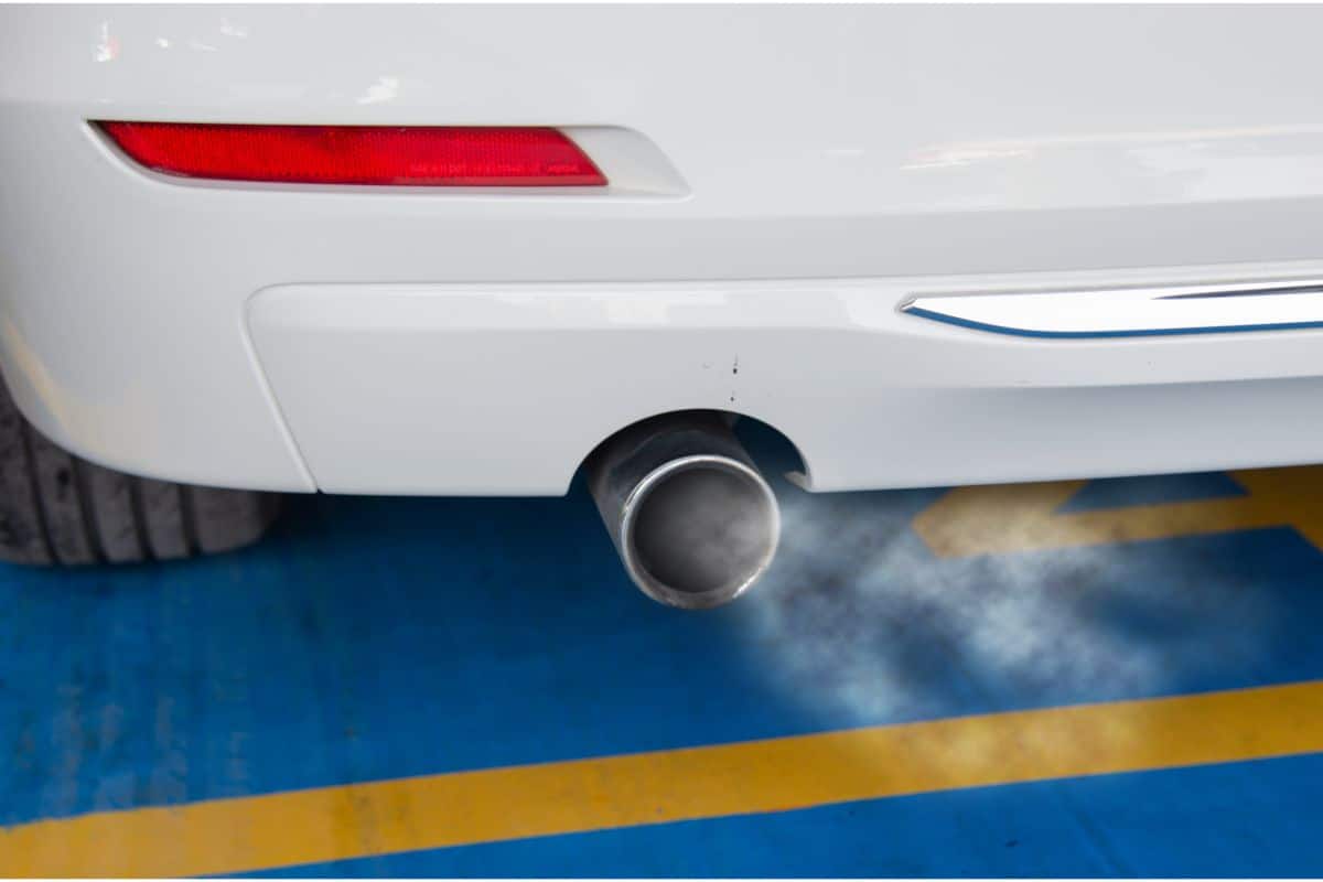 photo of a car exhaust pipe with fumes being emitted