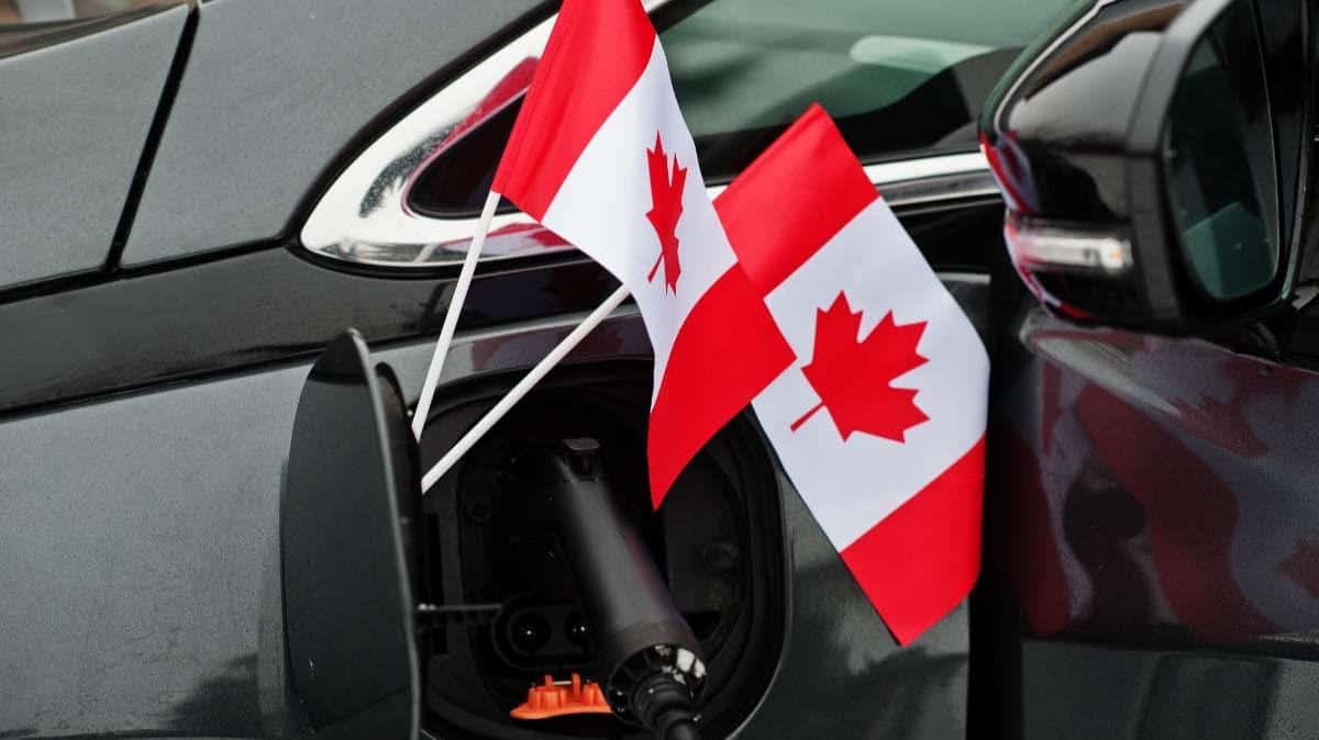canada-flag-ecological-car-concept-plugging-a-power-charger-in