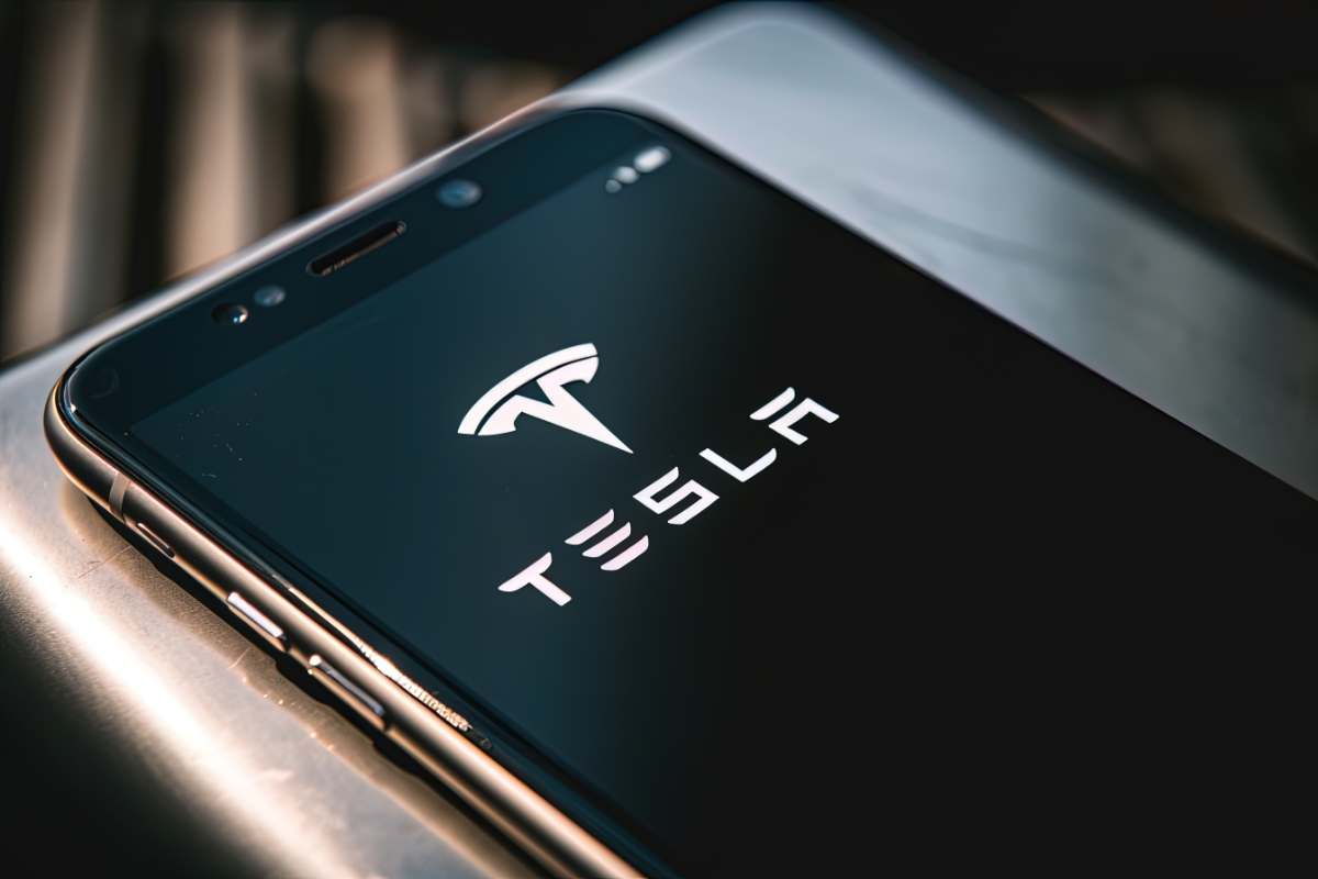 tesla app on cell phone showing tesla logo