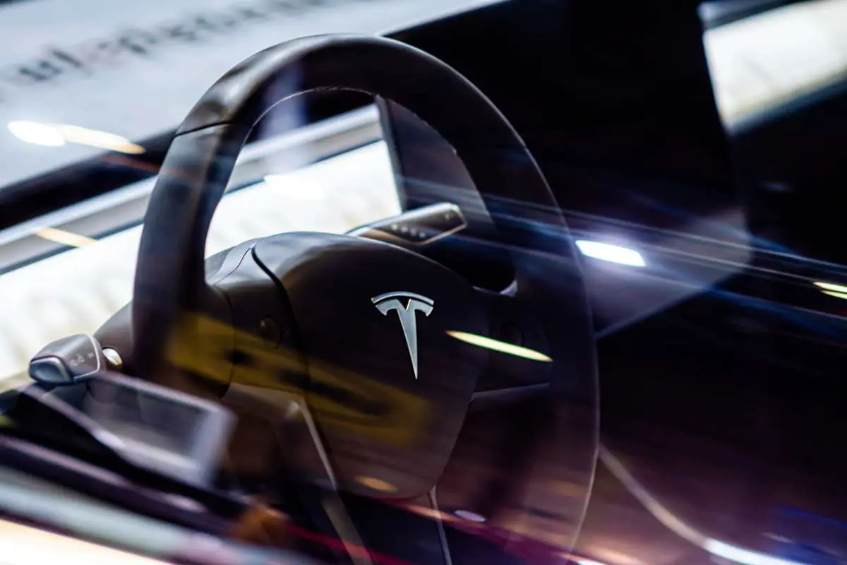 Interior of electric vehicle Tesla, steering wheel, Tesla logo